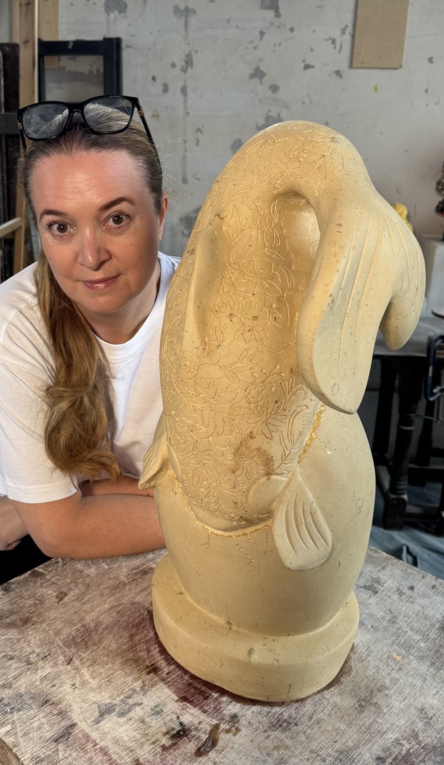 Lauren Super in the studio with a hand-carved limestone sculpture
