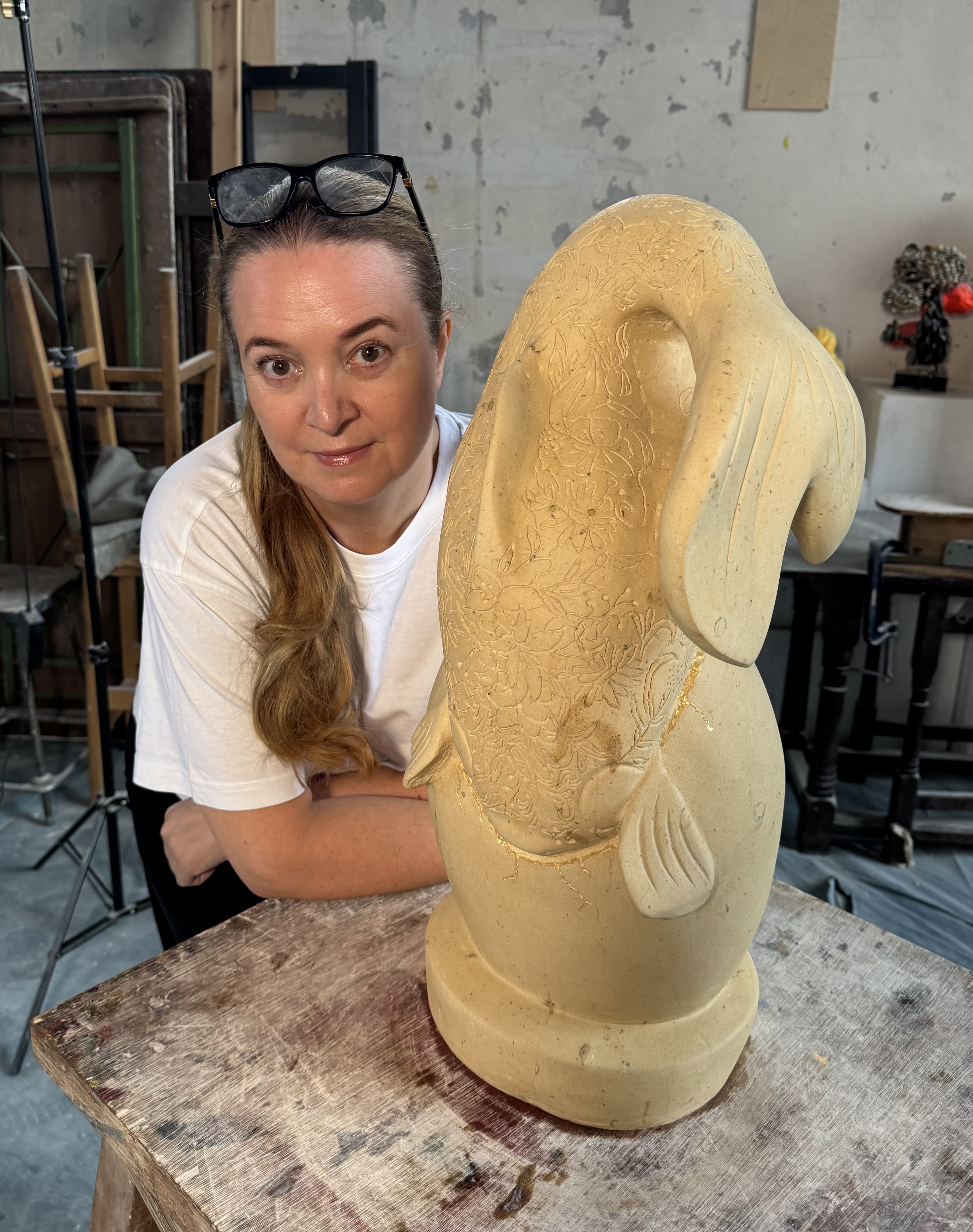 Lauren Super with The Golden Child sculpture in the studio